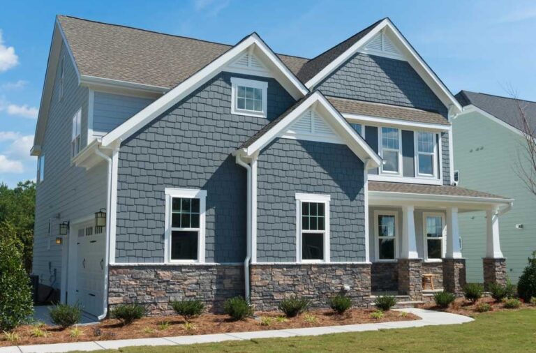 Modern suburban house with blue siding.