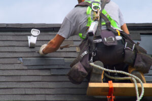 Roofing contractor repairing damaged shingles, Katy