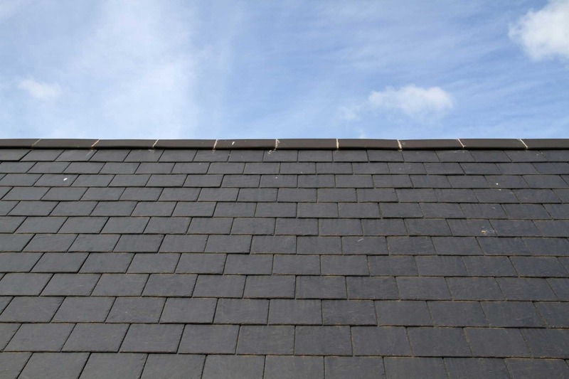 Close-up of natural slate shingles on a newly installed roof in Tomball